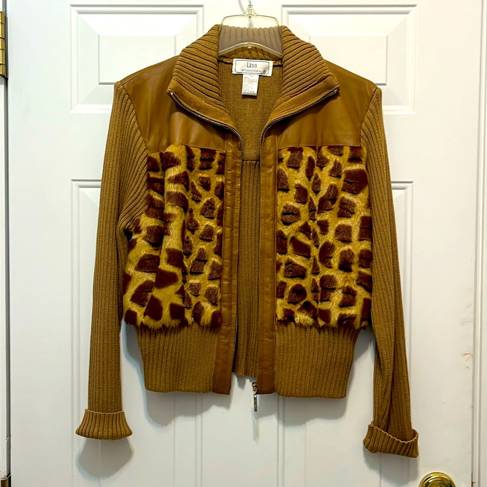 Leather and knit jacket with faux fur detail.